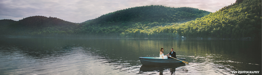 Row boat ride after a wedding ceremony in the heart of the Adirondacks